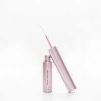Pink eyebrow mascara with cap on a white background
