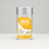 Jar of ellips hair vitamins with a silver lid on a gray background