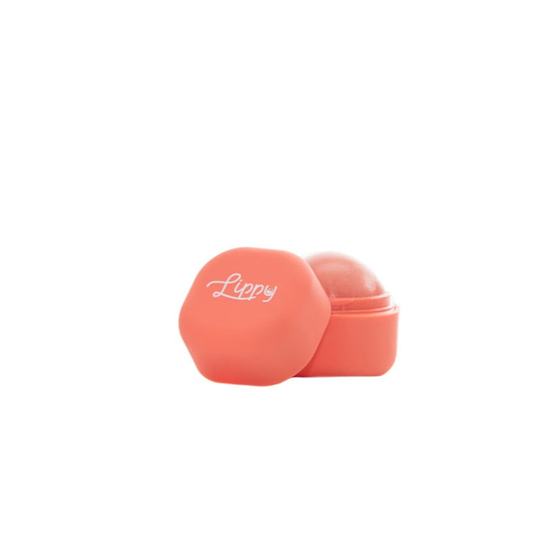 Coral-colored lip balm on a white background